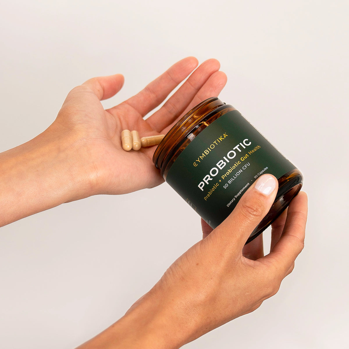 Probiotic Pills Poured out Onto Hands from Jar