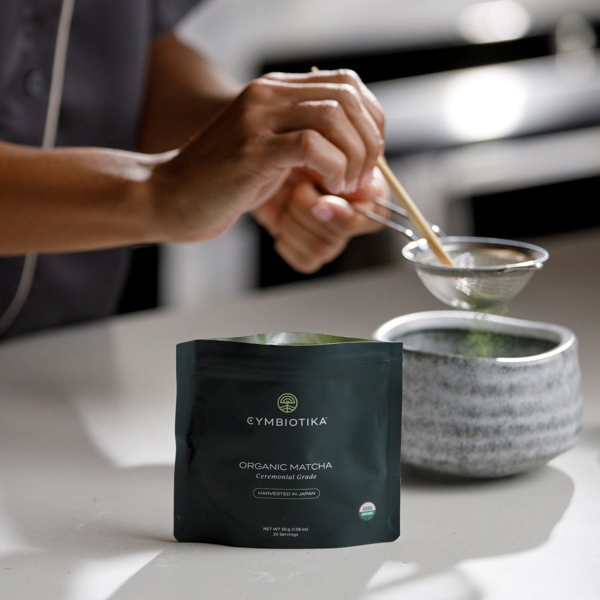Organic Matcha Being Sieved into Cup from Bag