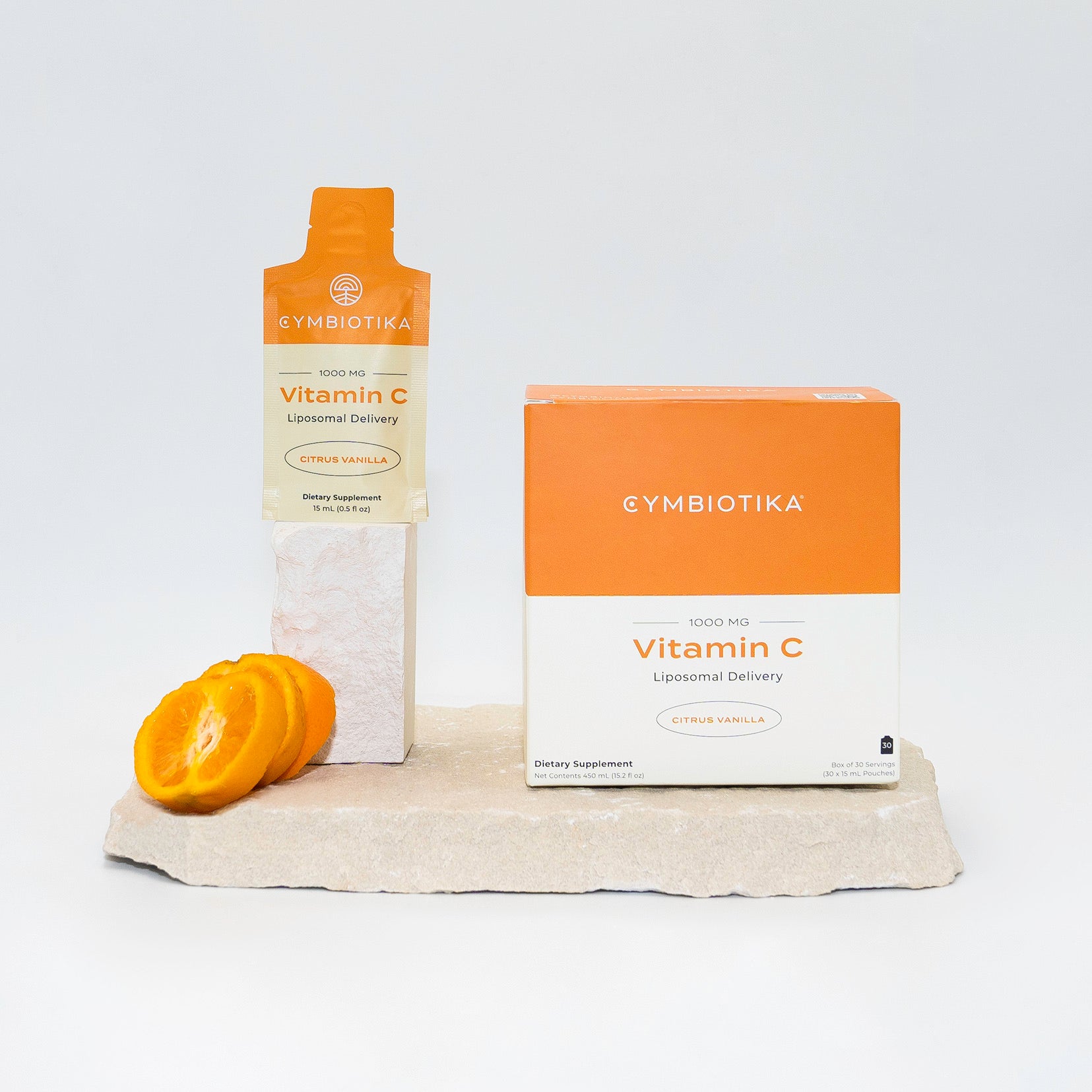 Liposomal Vitamin C On Stone Next to Oranges