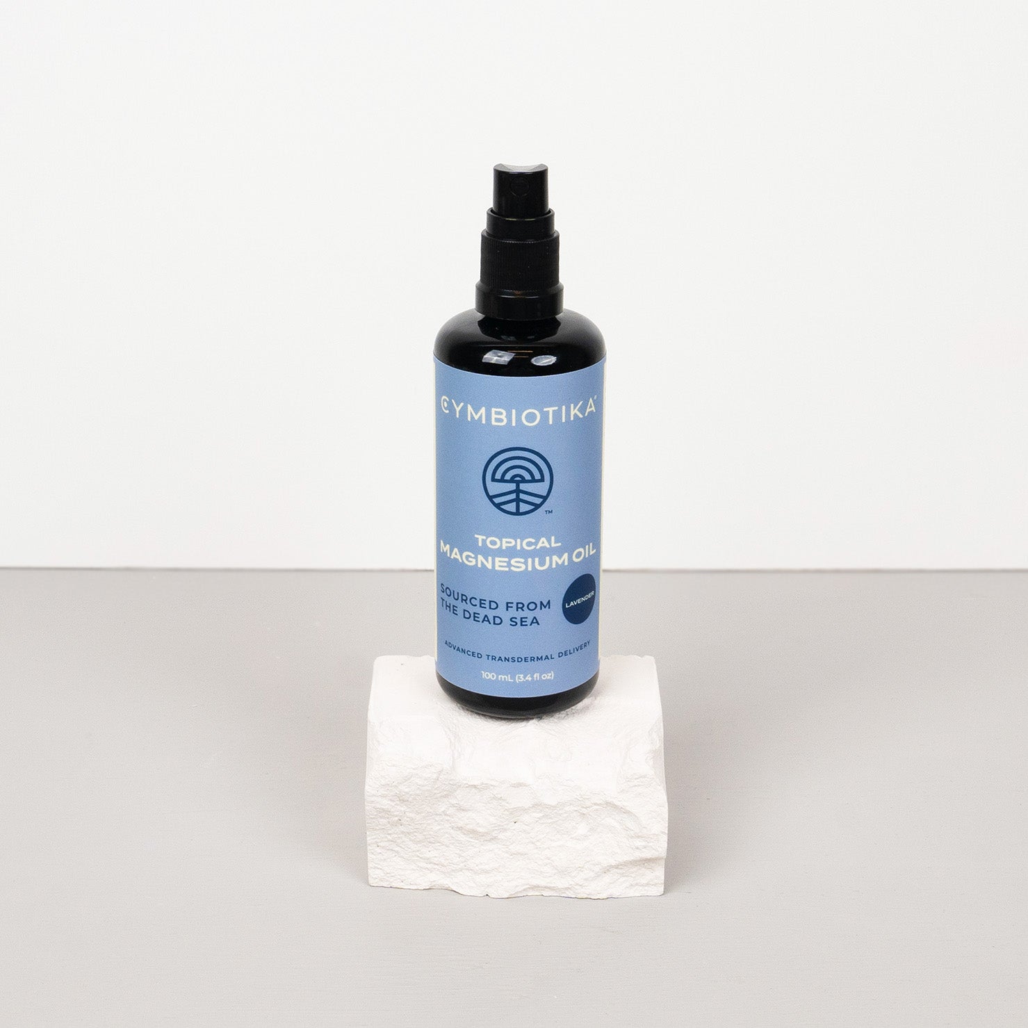 Topical Magnesium Oil Spray Bottle on Stone
