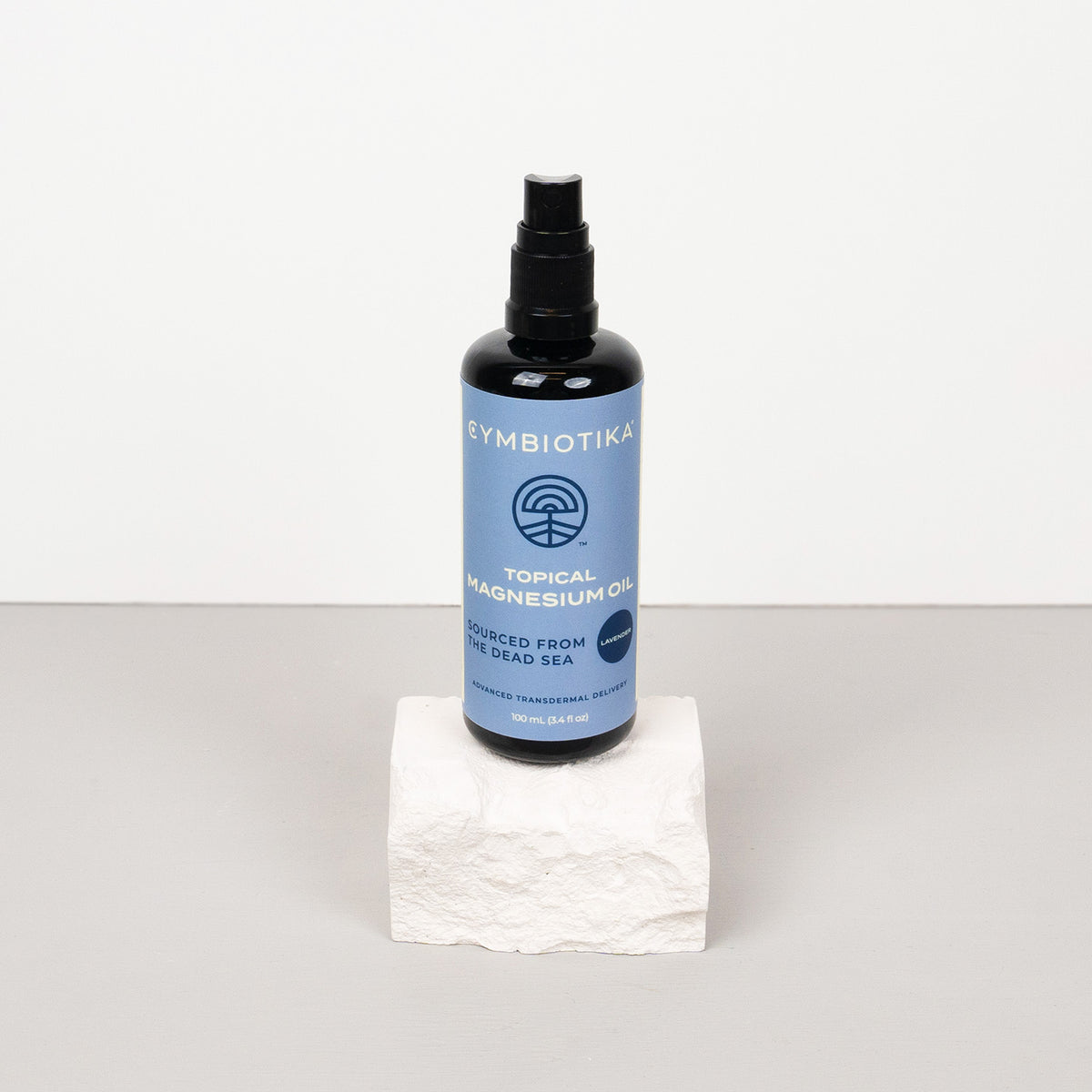 Topical Magnesium Oil Spray Bottle on Stone