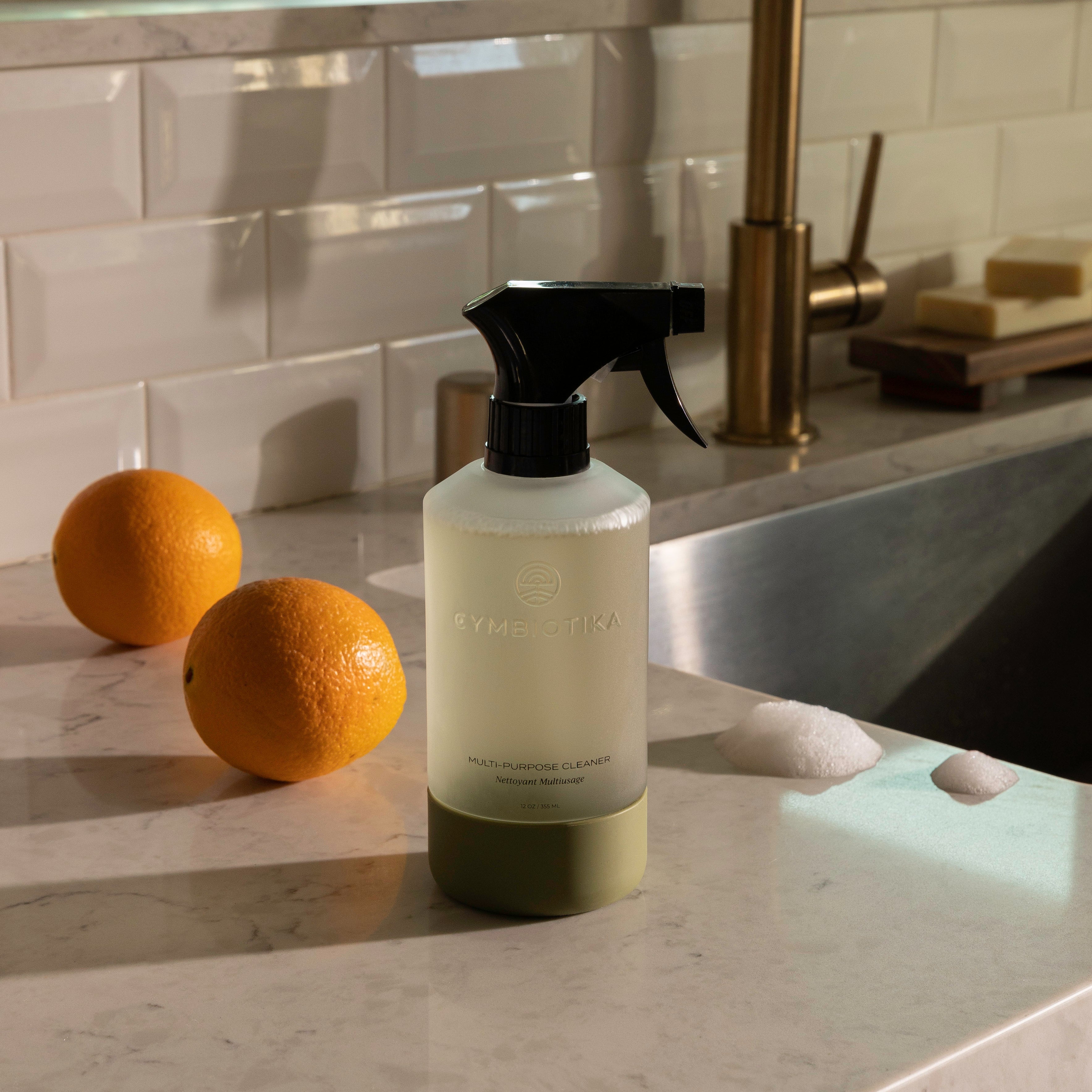 Multi-Purpose Cleaner Bottle next to Oranges on Counter